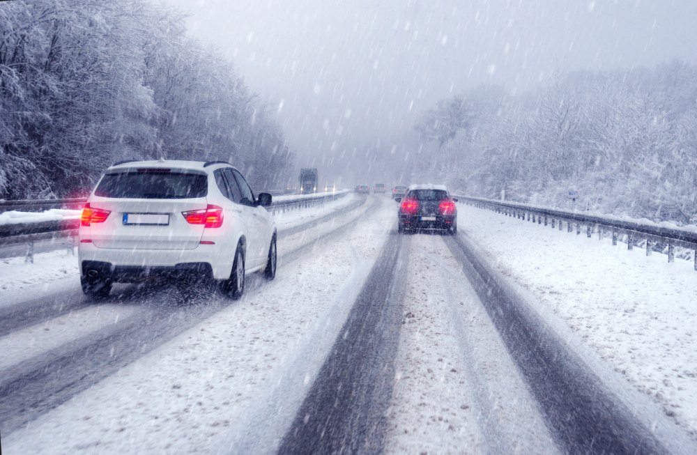 photo: two cars drive on a snowy highway