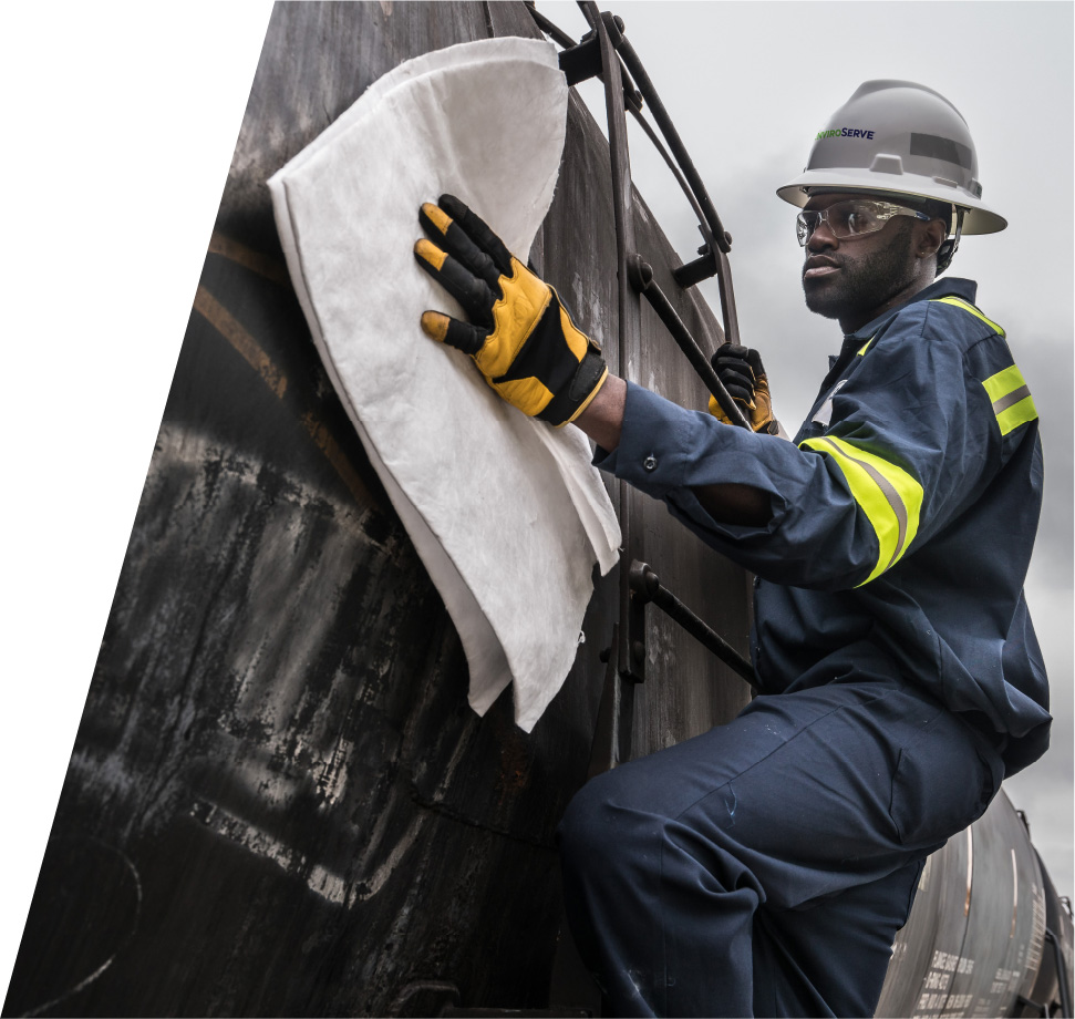 pictured: an EnviroServe worker climbs the side of a tanker