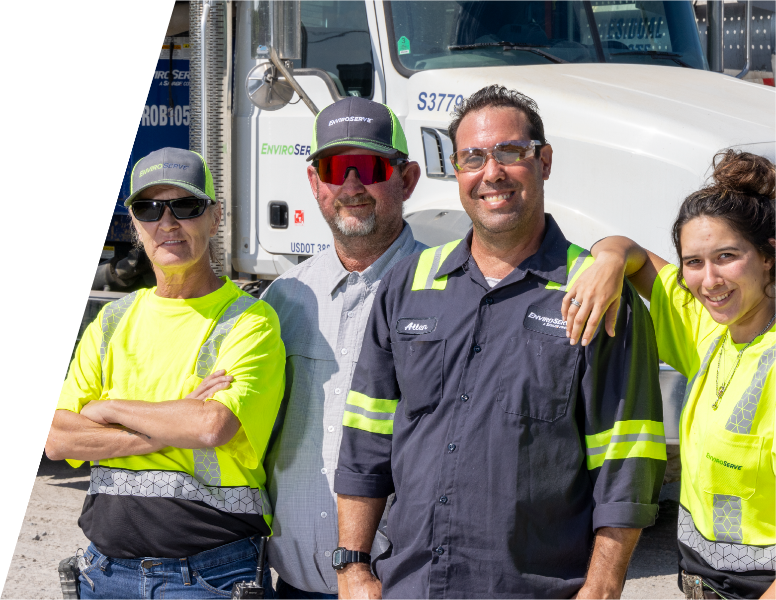 pictured: four EnviroServe workers wear safety yellow and pose in front of a truck