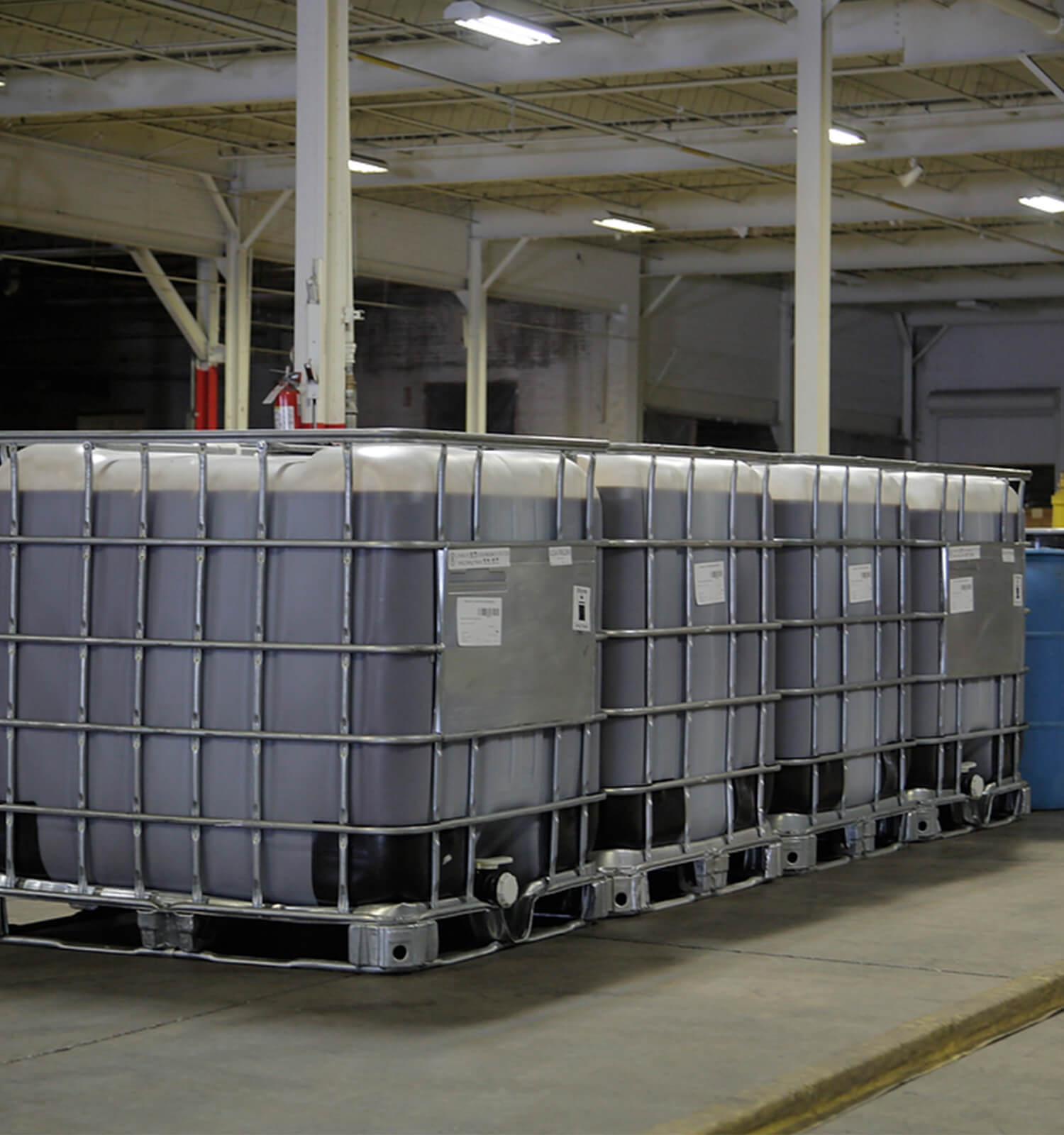 pictured: bulk liquid containers inside a warehouse