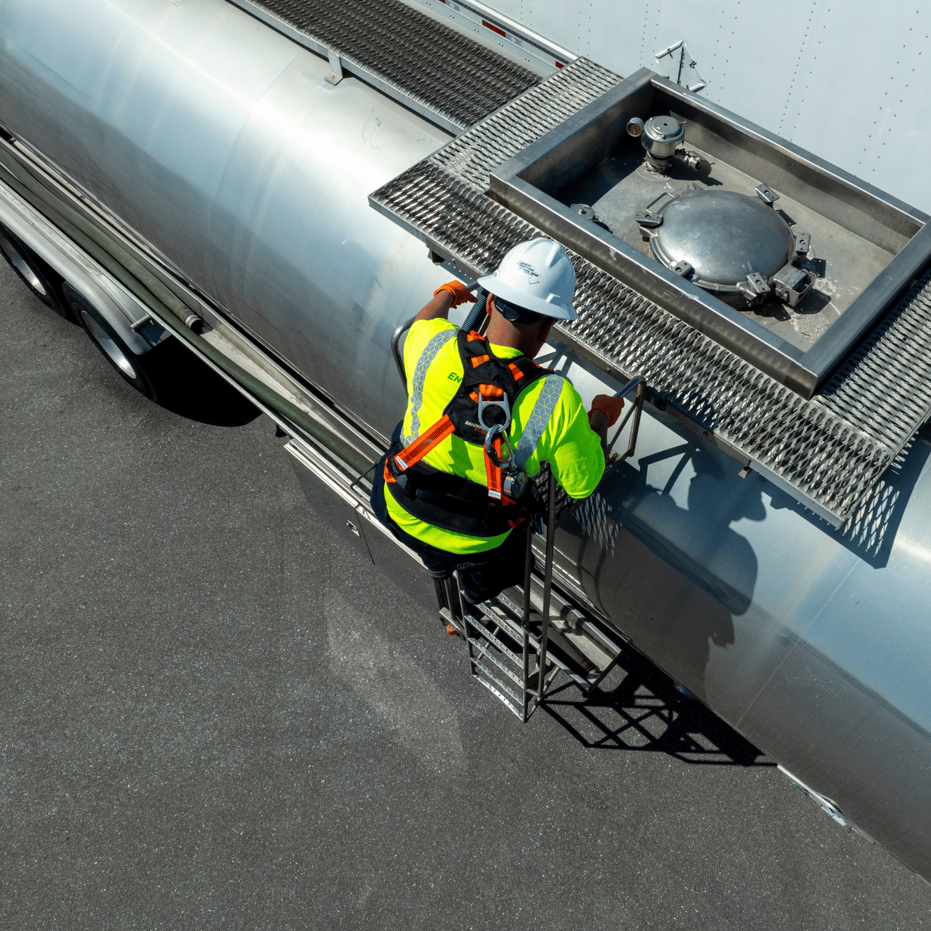 pictured: an EnviroServe worker climbs the side of a tanker