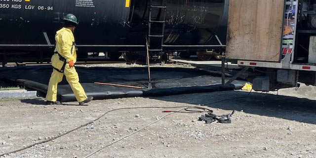 Person cleaning railcar