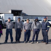 seven members of the EnviroServe Tampa team pose outside the facility