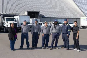 seven members of the EnviroServe Tampa team pose outside the facility